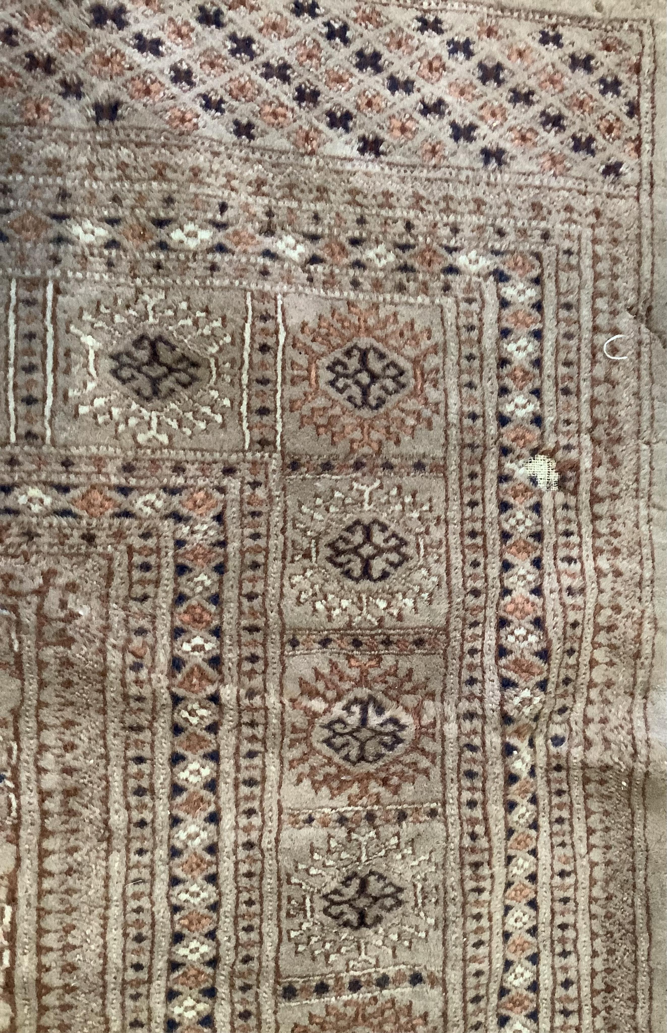 A Bokhara peach ground carpet, 320 x 215cm. Condition - poor to fair